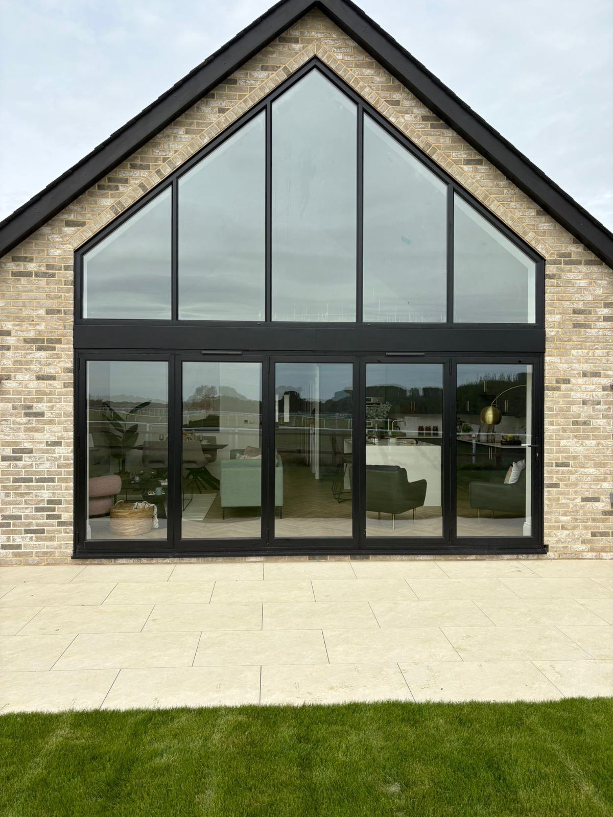 Full-height triangular gable feature window installed on a modern Kent extension