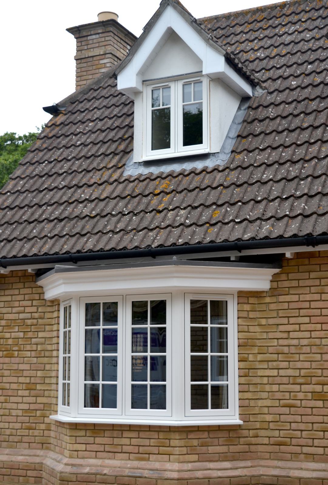 White uPVC dormer window installed in a tiled roof on a Surrey family home